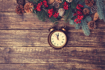 vintage alarm clock with branch of pine