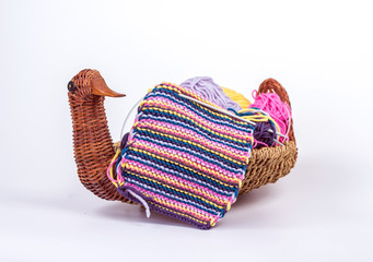 piece of knitting with a ball in a wicker basket - duck