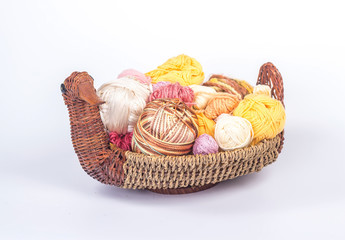 Fototapeta na wymiar multi-colored balls of yarn in a wicker basket - duck
