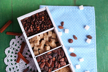 Wooden box with set of coffee and cocoa beans, sugar cubes