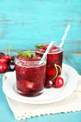 Closeup of cherry granita in glasses, on color wooden