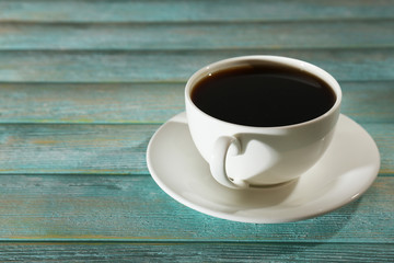 Cup of coffee on wooden table