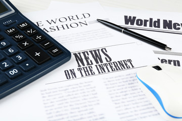 On-line news and business concept. Computer mouse, calculator