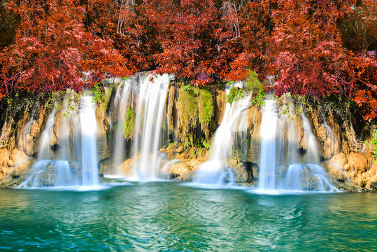 Fototapeta Beautiful waterfall in autumn forest