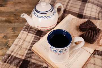 Fototapeta na wymiar Cup of tea with book on table close-up