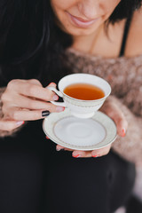 Young woman having picnic: drinking tea and reading book