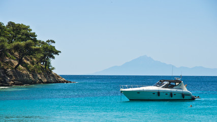 Fototapeta na wymiar Boat anchored in a small bay at Thassos island