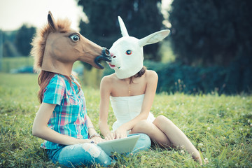 mask horse and rabbit women sisters friends using smartphone and