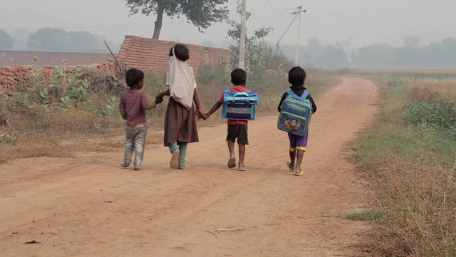 Indian children are on a rural road