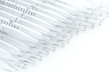 plastic pipette in a row isolated on white