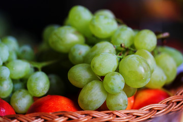 White green grapes on wooden basket