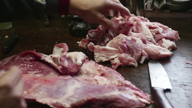 Old butcher preparing meat in slow motion