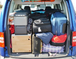 Suitcases and bags in the luggage boot of a car