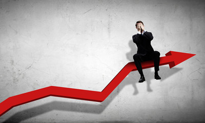 Businessman sitting on graph