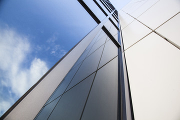 facade of white office building with blue sky