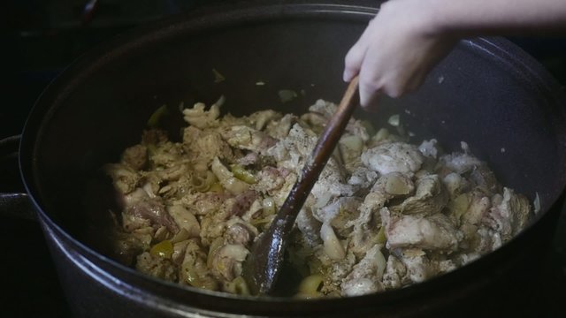 Hands Stirring Meat Inside Big Pot In Slow Motion