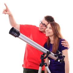 Two people observe through a telescope