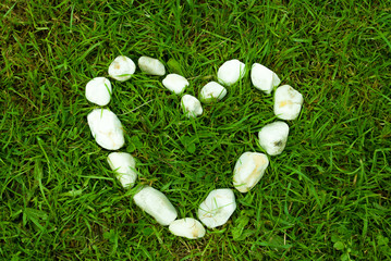 Heart of stones on grass