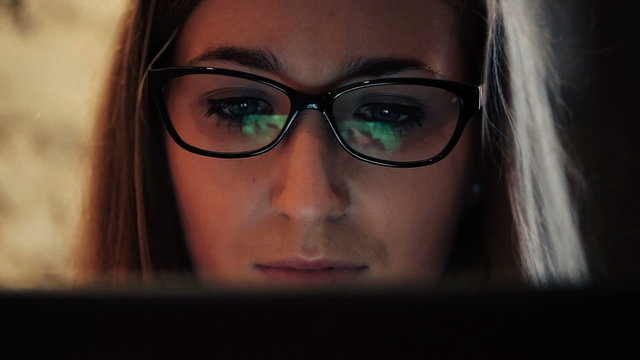 Closeup shot of woman face surfing internet on tablet computer