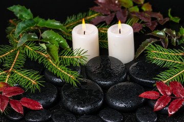 winter spa concept of zen basalt stones with drops, candles and