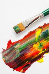 Paintbrush and mixed rainbow oil paints on artist canvas