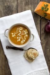 Fototapeta na wymiar Bowl of hot pumpkin soup with cream