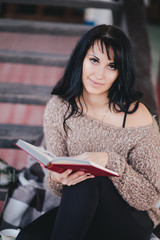 Obraz premium Young woman having picnic: drinking tea and reading book