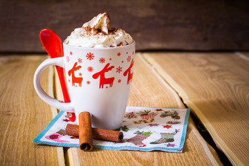 Hot chocolate with whipped cream in a mug with reindeer - 73745085