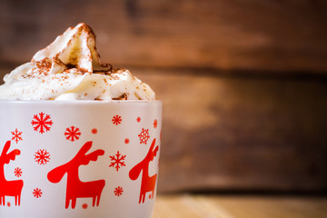Hot chocolate with whipped cream in a mug, close view