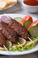kebabs with ketchup and fresh vegetables vertical