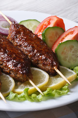 delicious kebabs and vegetables on a plate close-up. vertical