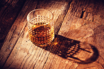 Strong alcohol on a wooden table - obrazy, fototapety, plakaty