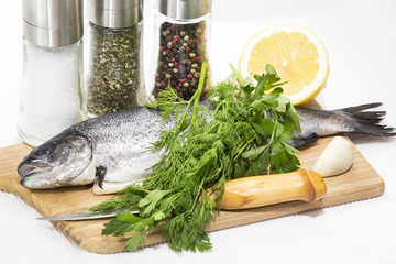 raw fish on a cutting board and knife