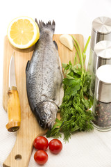raw fish on a cutting board and knife