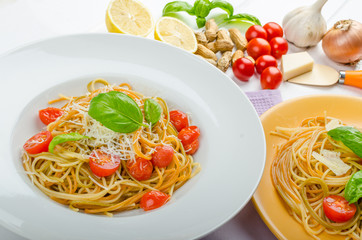 Lemon pasta with cherry tomatoes, basil and nuts