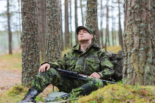 Soldier Or Hunter With Gun Sleeping In Forest