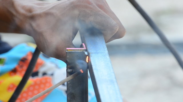 Construction worker welding steel.