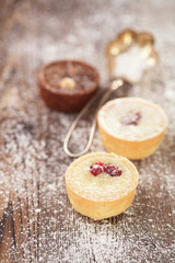 Chocolate dark and white Mini Tartlets in rustic style on wooden