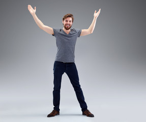 Young man with beard in victory pose