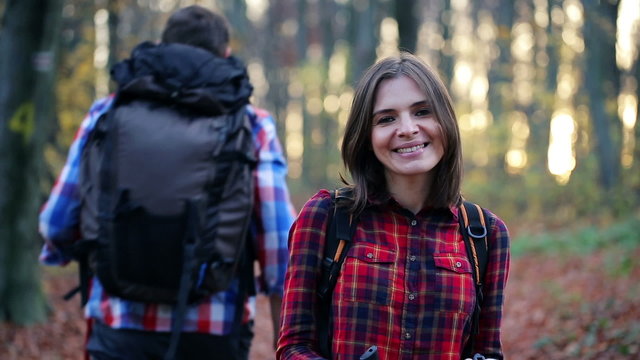 Portrait of happy female hiker in autumn forest
