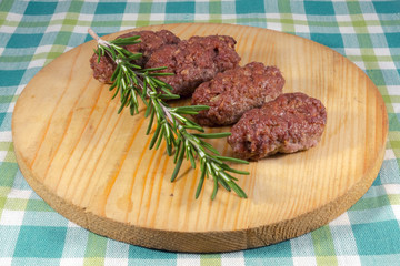 Cevapcici on a wooden dish