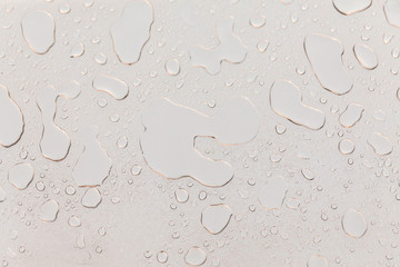 Metal surface covered in water drops.