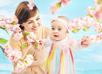 Fototapeta premium Smiling mom holding her daughter