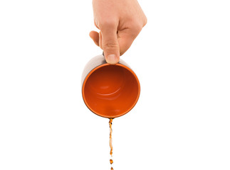 hand with coffee flowing out from mug