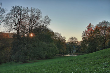 Fototapeta na wymiar Autumn park and small lake at sunset