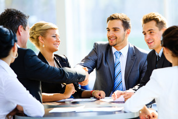 Two businessmen handshaking after striking grand deal