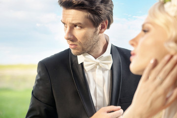 Serious groom with his lovely wife