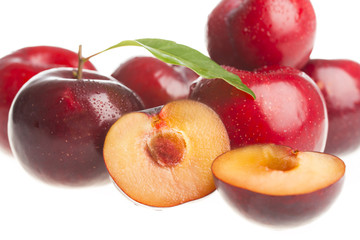Red plums isolated on white background