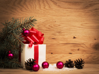 Fototapeta na wymiar green fir branches on the wooden floor with gifts