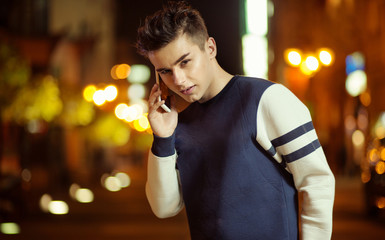 Teeange charming boy taling on the smartphone